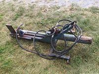 Side view of entire log splitter showing beam, cylinder and hoses