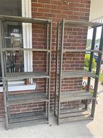 Two wooden wood shelving units side by side against a brick wall, each with four shelves, showing overall structure and size.