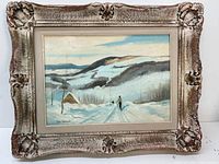 Framed oil painting of a winter landscape with hills, small cabin, and skier in snow signed John Dermont.