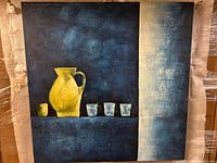 Full front view of the painting showing the yellow pitcher and four cups on a shelf, textured blue background with white vertical section right side