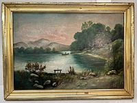 Full view of old oil on board painting in gold frame showing river, fisherman in boat, trees, rocks, and mountains.