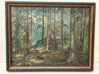 Full view of the framed oil painting showing a forest scene with trees and light filtering through leaves.