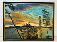 Full view of the framed colorful landscape oil painting showing trees, water, and sunset sky.