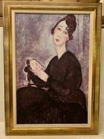 Full view of framed art print showing gold frame and artwork