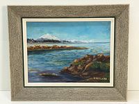 Full framed view of the oil painting depicting Mount Baker and rocky coastal foreground with blue sky.