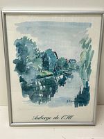 Framed watercolor painting of a river scene with trees and buildings titled 'Auberge de L'Ill'