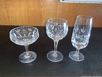 Three crystal glasses showing coupe, wine and flute shapes with cut pattern