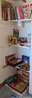 Overview of shelves showing children's books along with various games and toys on lower shelves