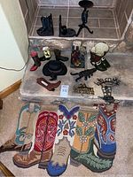 Full view of decorative cowboy boot figurines, bookends, cowboy hat, brass horse figurine, welcome sign, and colorful cowboy boot patterned rug.