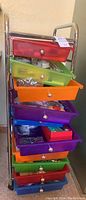 Full view of the metal rolling cart with colorful plastic drawers containing craft supplies