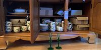 Cabinet shelves showing stacks of Desert Rose dinnerware