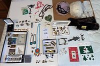 Overall assortment of pins, jewelry, hats, fur and gloves on table