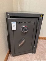 Front view of closed Winchester safe showing digital keypad, handle and branding