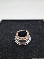 Top view of Birks sterling silver ring box base showing black velvet insert and round shape.