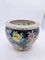 View of the exterior showing black glazed porcelain with colorful floral designs and decorative rim