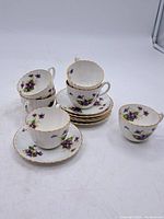 Full set of six Radford Crown China cups with six matching saucers, arranged showing floral designs and gold trim.