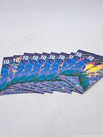 Ten unopened booklets of Canadian stamps arranged slightly overlapping.