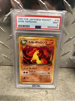 Photo of Dark Rapidash Pokemon card graded PSA 9 mint, encased in plastic slab with PSA label.