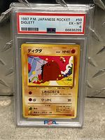Front view of 1997 Japanese Team Rocket Diglett Pokémon card graded PSA 6 EX MT in protective slab.