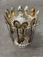 Front view of compotier with spoons hanging