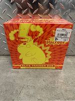 Front view of sealed Vivid Voltage Elite Trainer Box with yellow Pikachu artwork against red background and pricing label on the top right corner.