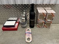 Full view of bottle, cocktail shaker, bottle opener, and boxed stemless wine glasses