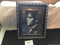 Overall view of the framed signed photo of Elvis Presley with visible signature and ornate frame.