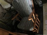 Glider rocker chair from an angled top view showing the cushion and armrest detail.