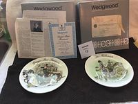 Two Wedgwood plates titled 'Ginger Beer Fountain' and 'The Milkman' with original boxes and certificates.