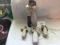Photo showing all four Willow Tree figurines including the couple and three angels.