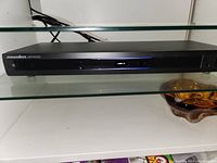 Photo of Panasonic MR4000 power management system, black slim rectangular device with indicator lights.