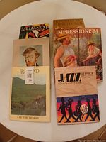 Overview of all 7 coffee table art books on white round table