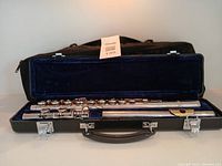 Flute disassembled in hard case with soft case behind