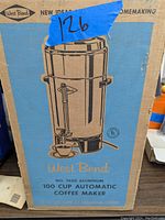 Original box of West Bend 100 cup automatic coffee maker, showing product illustration and branding.