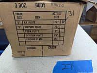 Cardboard box label showing item details and size confirmation of 7 3/4 inches
