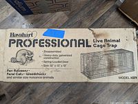 Closed box of Havahart Professional live animal cage trap showing product details, size, and intended animals for capture.