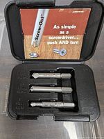 Screw out bit set with three bits in a black case showing detailed bit sizes and the Screw-Out brand.