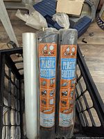 Two sealed rolls of Frost King heavy gauge plastic sheeting in original packaging showing product branding and size.