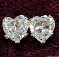 Close-up front view of heart-shaped cubic zirconia stones set in 14K gold prongs.