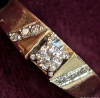 Close-up of ring face showing central and accent diamonds