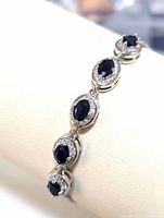 Close-up image of the sapphire and cubic zirconia bracelet showing the oval stones and the silver setting.