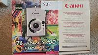 Front of the original colorful box showing the Canon PowerShot S400 camera image and branding with megapixel and zoom details