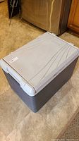 Full view of Coleman refrigerator cooler showing gray exterior and lid