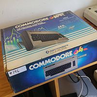 Original boxed Commodore 64 with full packaging and box art details.