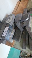 Multiple lead blocks and bars piled on a surface, some marked with label #316