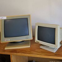 Front view of Samsung and Axion CRT monitors showing their screens and front panel details.