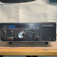 Front view showing all control knobs, switches, meter, and display panel on the Yaesu FRG-7000 receiver.
