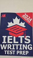 Photo of the front cover of an IELTS Writing Test Prep book with 2024 updated content.