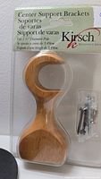 Photo showing new wooden center support bracket in packaging with screws, labeled Kirsch, fitting 1 3/8" diameter poles.
