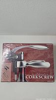 Front view of sealed box showing Costco professional corkscrew with foil cutter and image of 2 extra screws on the side.